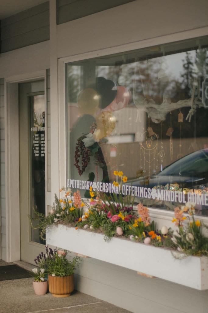 storefront photo of the Onyx Moon with window and flowers photo by Tori Winn Photography