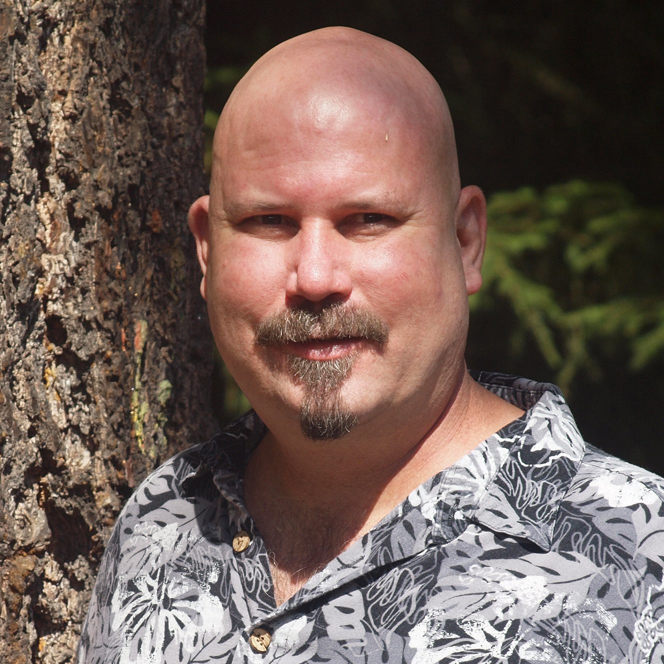 Monty Burgess picture in the forest leaning against a tree